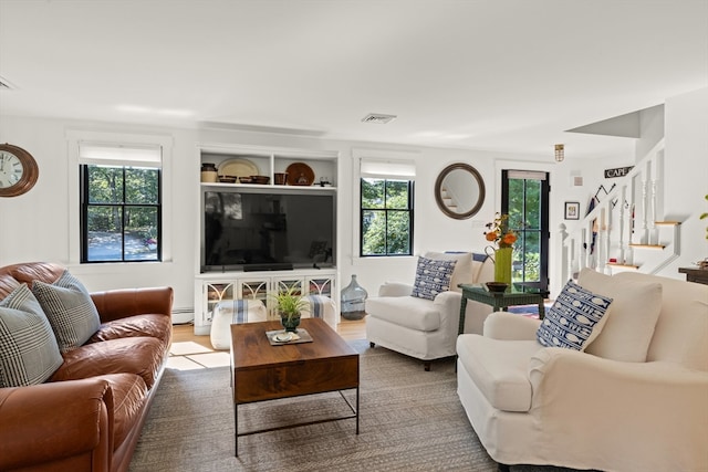 living room featuring baseboard heating and wood-type flooring