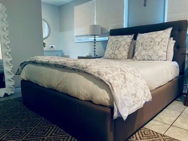 bedroom with light tile patterned flooring