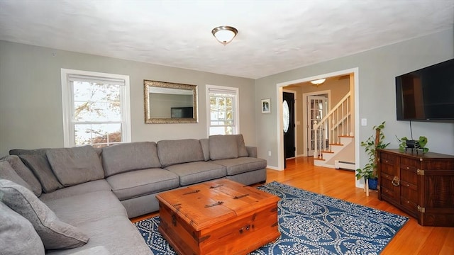 36 Jean Dr, North Attleboro, MA 02760 - living room featuring a baseboard radiator, plenty of natural light, light wood finished floors, and stairs