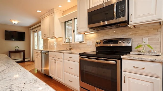 36 Jean Dr, North Attleboro, MA 02760 - kitchen with stainless steel appliances, a sink, light wood-type flooring, recessed lighting, and backsplash
