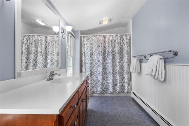 full bath with tile patterned flooring, vanity, a shower with shower curtain, a baseboard heating unit, and vaulted ceiling