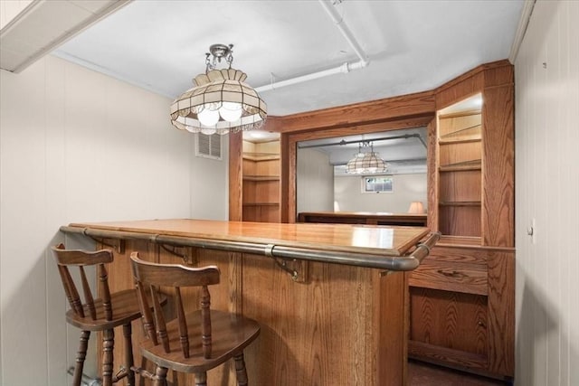 bar with a bar, visible vents, and hanging light fixtures