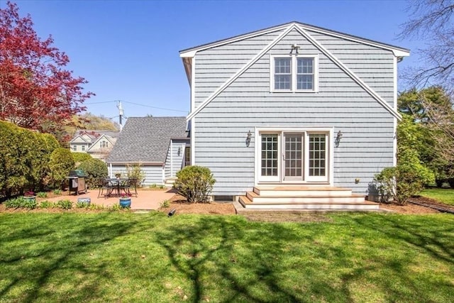 rear view of house featuring a lawn and a patio area