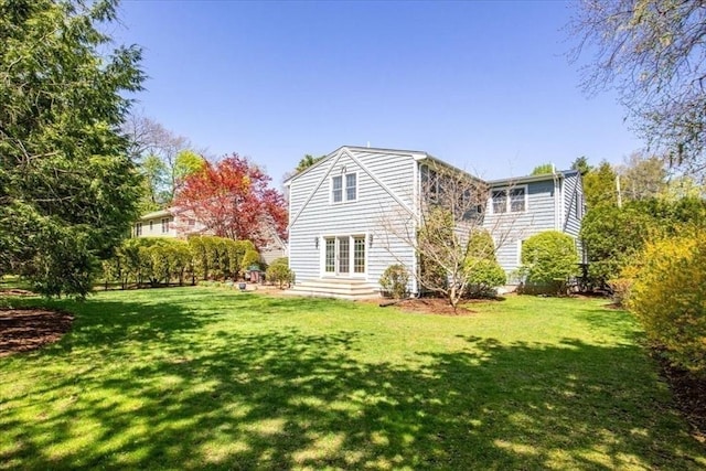 back of house with a yard and french doors