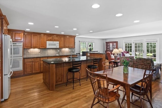 dining area with recessed lighting and light wood finished floors