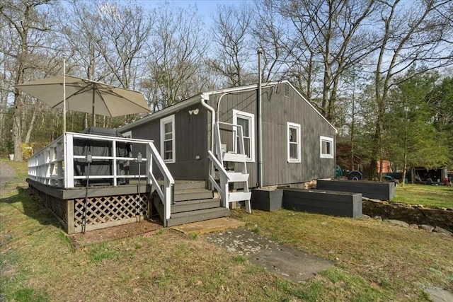 rear view of property with a wooden deck