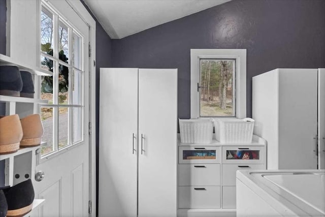 interior space with lofted ceiling and washer / clothes dryer