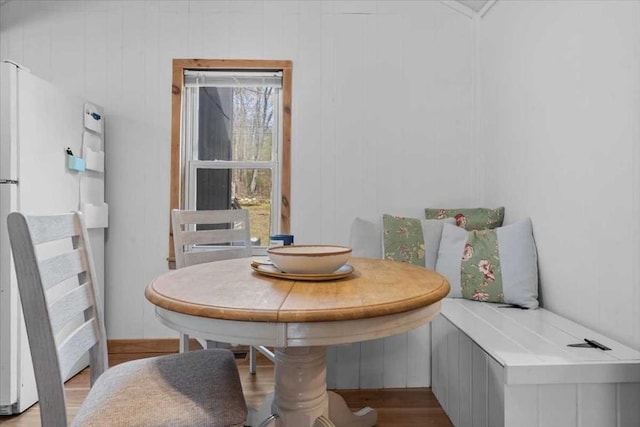 dining room with breakfast area and wood finished floors