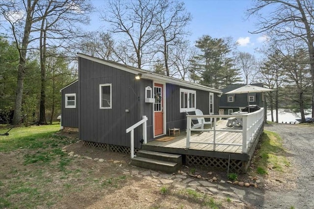 back of property featuring a wooden deck