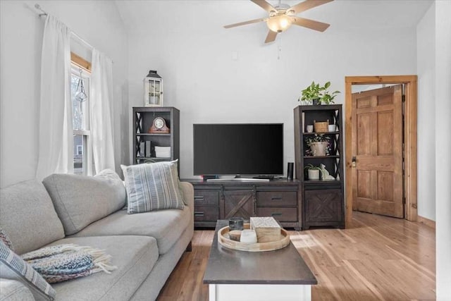living room featuring wood finished floors, ceiling fan, and vaulted ceiling
