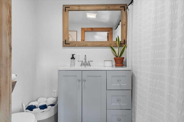 bathroom with vanity, toilet, and a shower with curtain