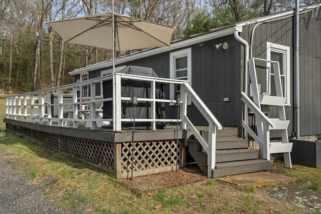 back of house with a deck