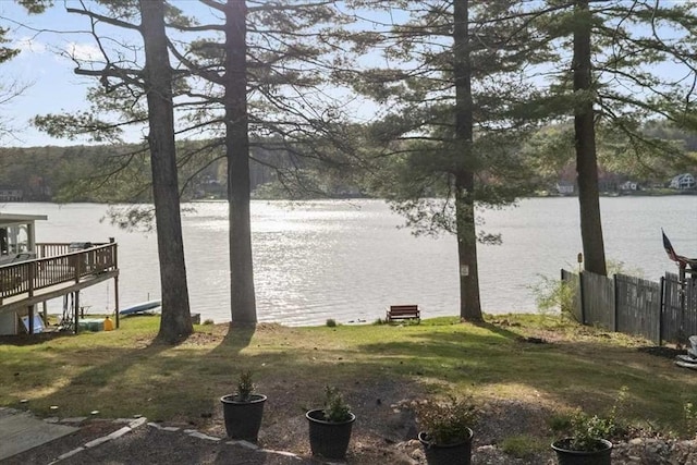 view of yard with a water view and fence