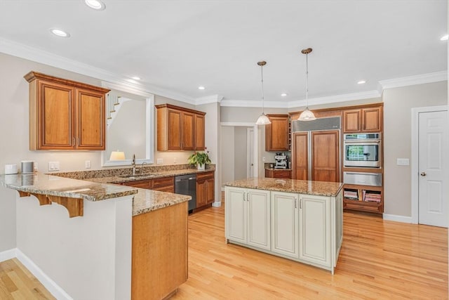 10 Whitney Rd, Stow, MA 01775 - kitchen with stainless steel appliances, a warming drawer, brown cabinets, light wood-style floors, and recessed lighting