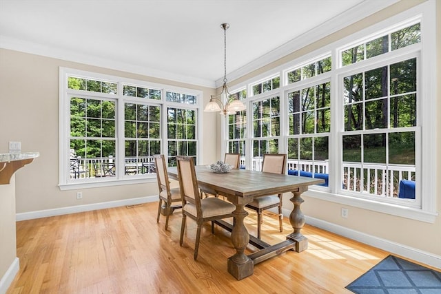 10 Whitney Rd, Stow, MA 01775 - dining area featuring baseboards, ornamental molding, light wood-style floors, and a chandelier