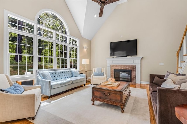 10 Whitney Rd, Stow, MA 01775 - living room featuring wood finished floors, ceiling fan, high vaulted ceiling, stairway, and a fireplace