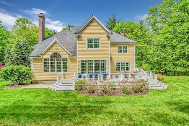 10 Whitney Rd, Stow, MA 01775 - rear view of property with a chimney, a lawn, and a wooden deck