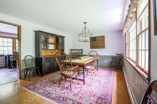 83 Everett Rd, Barre, MA 01005 - dining area featuring healthy amount of natural light, wood finished floors, a chandelier, and a baseboard heating unit