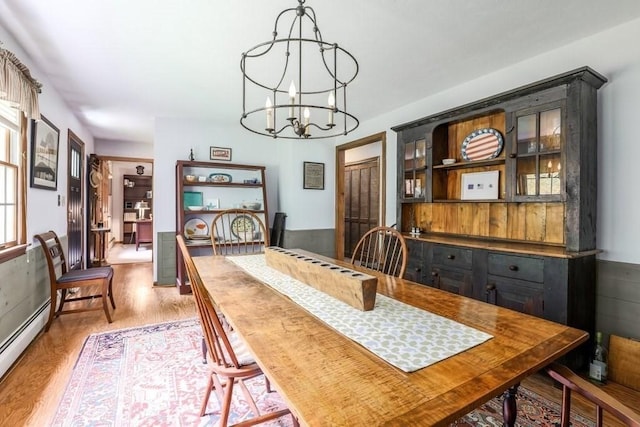 83 Everett Rd, Barre, MA 01005 - dining space featuring a baseboard heating unit, a chandelier, and wood finished floors
