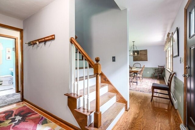 83 Everett Rd, Barre, MA 01005 - stairs with wood finished floors and a chandelier
