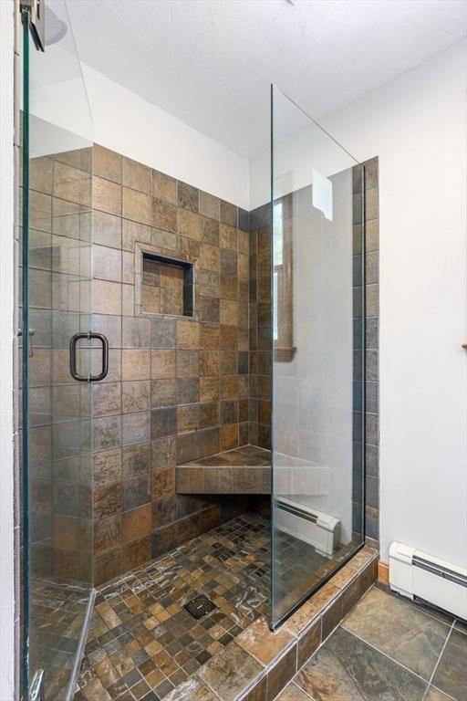 83 Everett Rd, Barre, MA 01005 - full bathroom with a baseboard heating unit, a stall shower, and a baseboard radiator