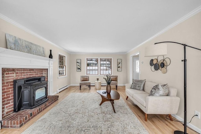 living area featuring a baseboard radiator, ornamental molding, a wood stove, wood finished floors, and baseboards