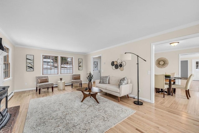 living area with light wood-type flooring, crown molding, baseboards, and a baseboard radiator