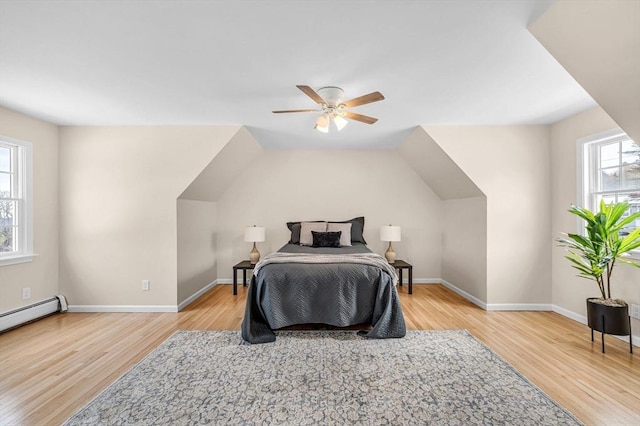 bedroom with ceiling fan, baseboards, vaulted ceiling, and wood finished floors