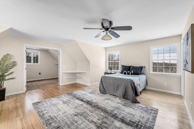 bedroom with baseboards, ceiling fan, and light wood finished floors