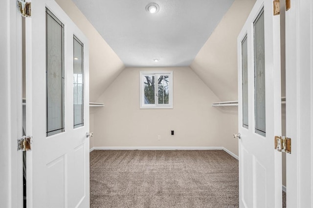 bonus room featuring carpet floors, baseboards, and lofted ceiling