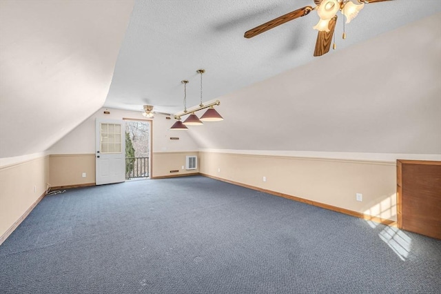 additional living space with lofted ceiling, ceiling fan, carpet flooring, and baseboards