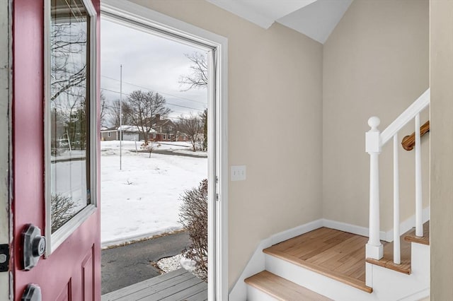 entryway featuring baseboards and stairway