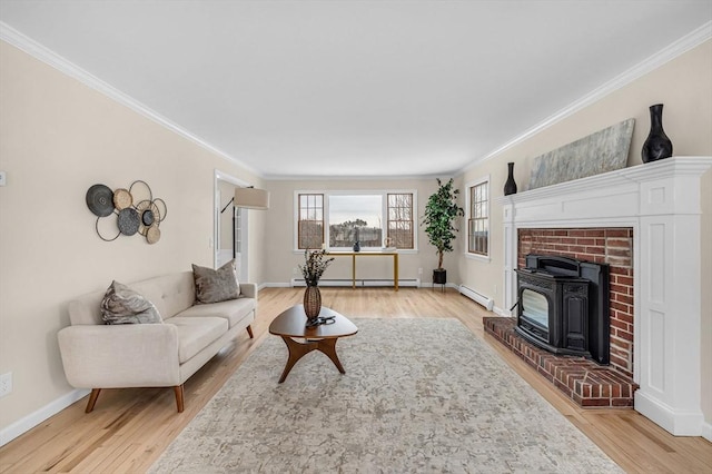 living area featuring light wood-type flooring, a baseboard radiator, and crown molding