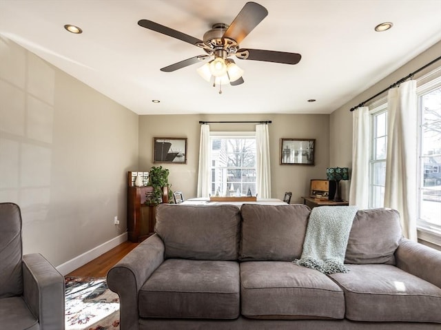 living room featuring hardwood / wood-style flooring and ceiling fan