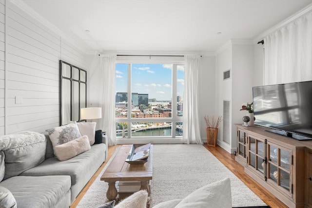 500 Atlantic Ave Unit 15M, Boston, MA 02110 - living area featuring wood finished floors, ornamental molding, and wooden walls