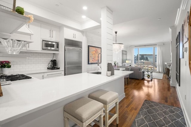 500 Atlantic Ave Unit 15M, Boston, MA 02110 - kitchen with built in appliances, open floor plan, tasteful backsplash, dark wood-style flooring, and recessed lighting