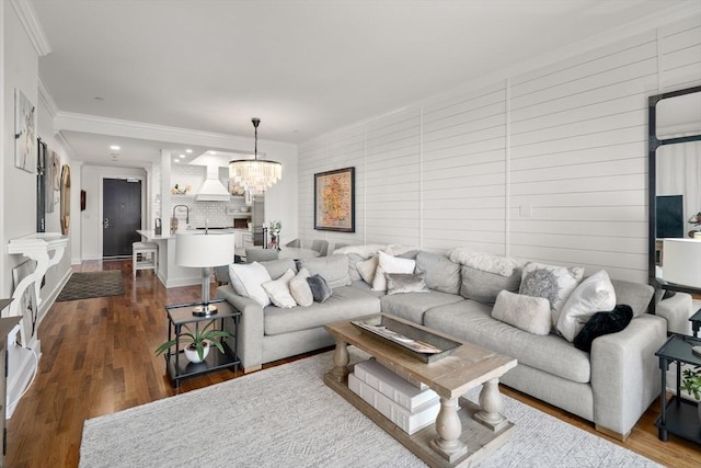 500 Atlantic Ave Unit 15M, Boston, MA 02110 - living room featuring a chandelier, crown molding, dark wood-style floors, wood walls, and recessed lighting