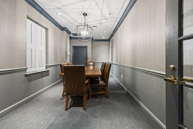 dining area featuring carpet, a chandelier, and ornamental molding