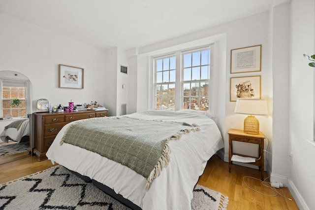 bedroom with light wood-type flooring