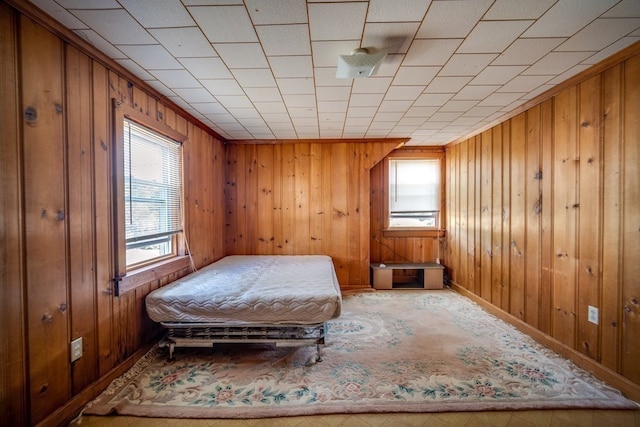 bedroom featuring wood walls