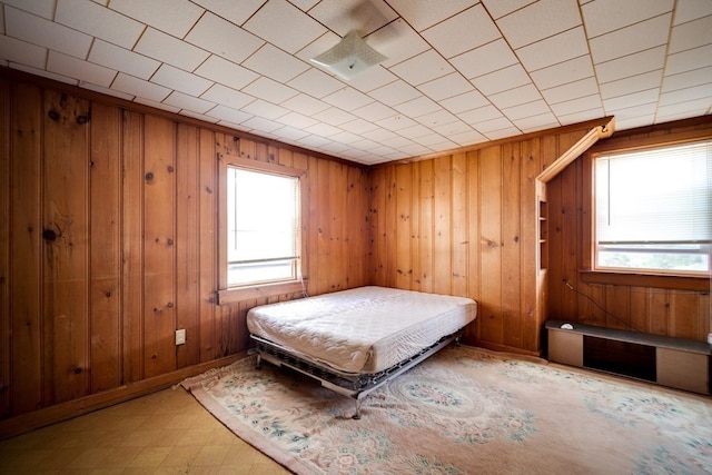 unfurnished bedroom featuring wood walls