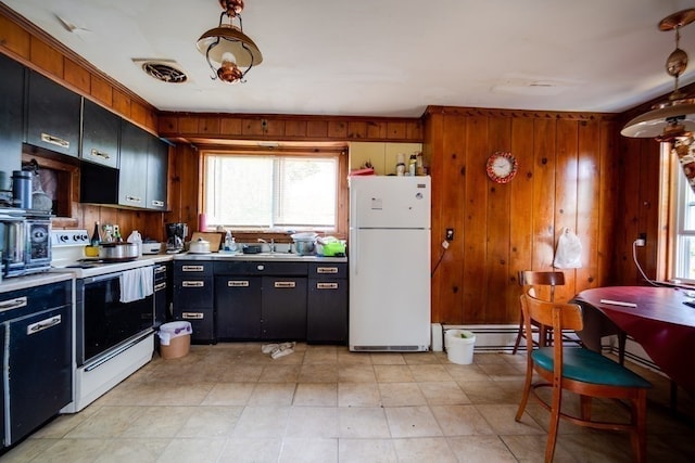 kitchen featuring white appliances, wooden walls, sink, light tile floors, and a baseboard heating unit