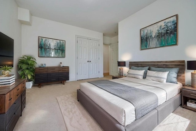 bedroom with a closet and light colored carpet