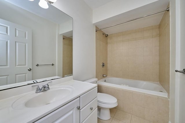bathroom featuring tiled shower / bath combo, vanity, tile patterned flooring, and toilet