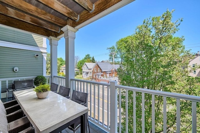 balcony with a residential view and outdoor dining space