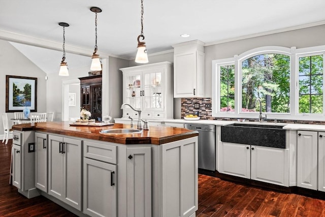 9 Wescott Rd, Andover, MA 01810 - kitchen featuring a sink, stainless steel dishwasher, wooden counters, dark wood-style floors, and a center island with sink