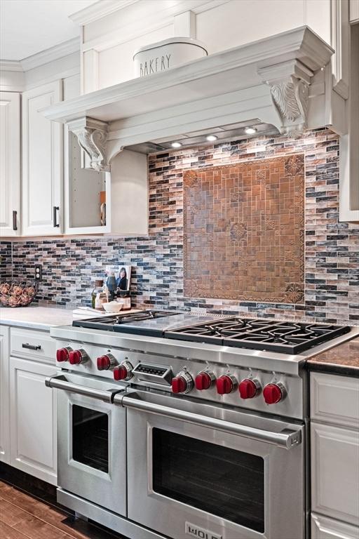 9 Wescott Rd, Andover, MA 01810 - kitchen featuring double oven range, backsplash, white cabinetry, ornamental molding, and wood finished floors