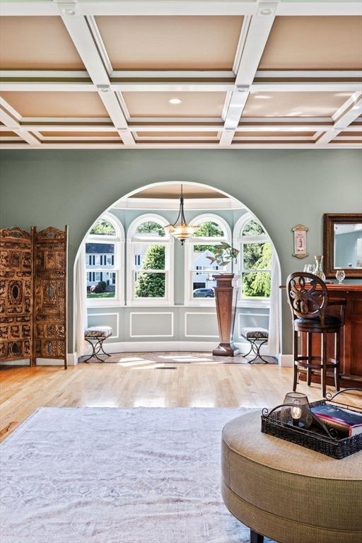 9 Wescott Rd, Andover, MA 01810 - sitting room featuring coffered ceiling, wood finished floors, beam ceiling, and arched walkways