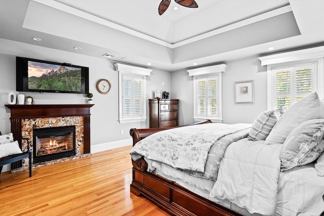 9 Wescott Rd, Andover, MA 01810 - bedroom featuring light wood-style floors, recessed lighting, multiple windows, a fireplace, and a raised ceiling
