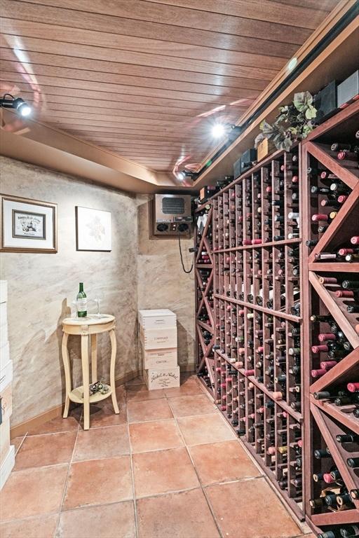 9 Wescott Rd, Andover, MA 01810 - wine cellar with wood ceiling, tile patterned flooring, and an AC wall unit